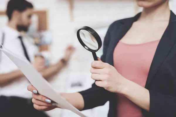 Private detective agency. Woman is posing with paper and magnifying glass, man is looking at clues map. — Stock Photo, Image