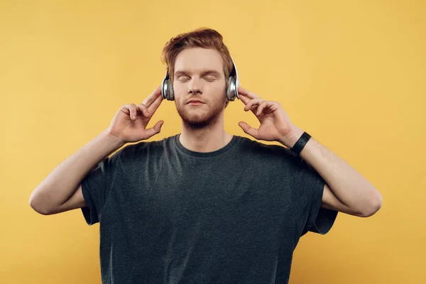 Fiatal férfi zenét hallgat fejhallgatóval — Stock Fotó