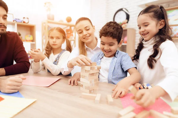 Bambini giocano a Jenga con gli adulti . — Foto Stock