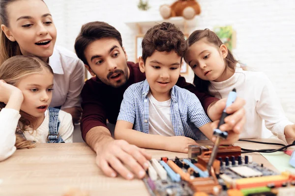 Kinder arbeiten gemeinsam mit der Lehrerin mit dem Lötkolben. — Stockfoto