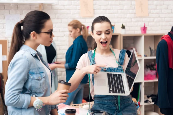 Three women at garment factory. They are looking for desing for new dress on laptop. — Stock Photo, Image