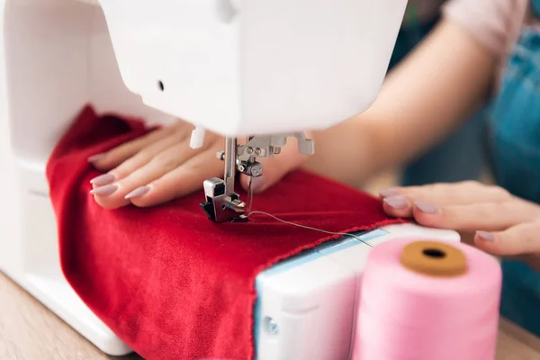 Close up of sewing machine. Girl at garment factory is sewing new dress. — Stock Photo, Image