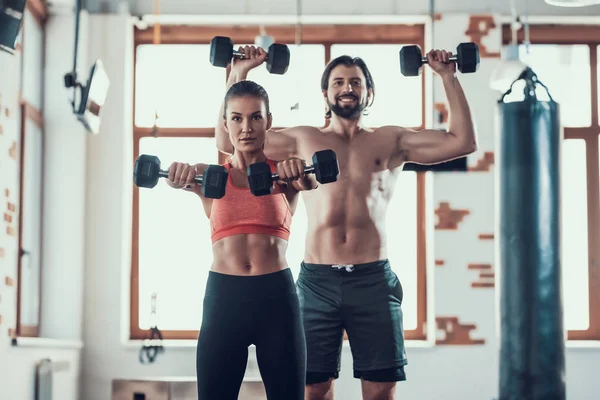 Girl And Guy In Gym Doing Dumbbells Exercises. Training Day. Fitness Club. Healthy Lifestyle. Powerful Athletes. Active Holidays. Crossfit Concept. Sportsman Without T Shirt. Sunny Day.