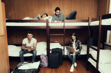Hostel for Young People. Best Friends Traveling. Small Room in Hostel. spend time Together. bunk beds in room. smiling People. Communicate. sit and lie on bed. Rest. work. read. listen to music clipart