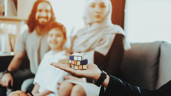 Arab Family at Reception in Psychotherapist. Family is Father, Mother and Son. Psychotherapist is Caucasian Man. Doctor is Holding Rubik\'s Cub in Hand. Psychologist Office. Blur View of Family.