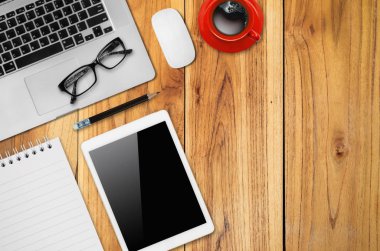 Ofis resepsiyon masası dizüstü, fare, dijital tablet, not defteri, kalem ve kahve fincanı ile kopya alanı görünümüyle Top.