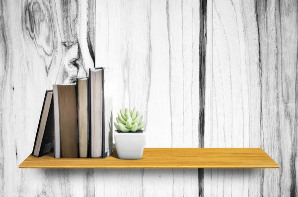 Top wooden shelves with cactus,book and wooden wall background - For product display.