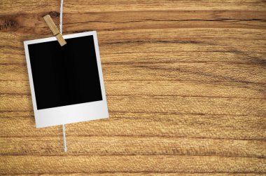 Kırpma yolu ile duvar arka plan asılı clothespin ile boş fotoğraf çerçevesi.