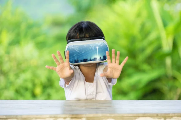 Child with virtual reality goggles dream trip around the world.