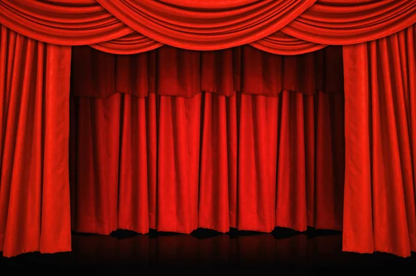 Red curtains and wooden stage floor.