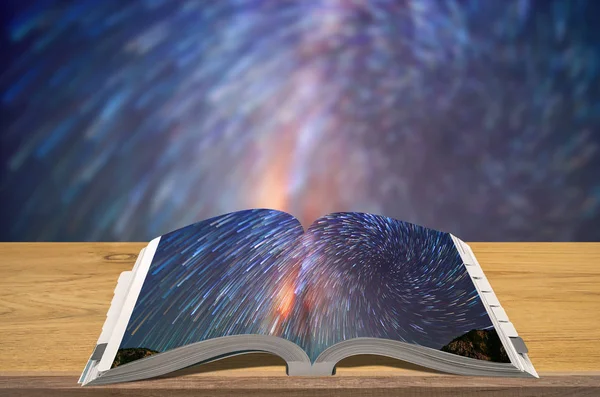 Creativity guidebooks travel, Open book on wooden table with blurred nature background, Scene Milky way.