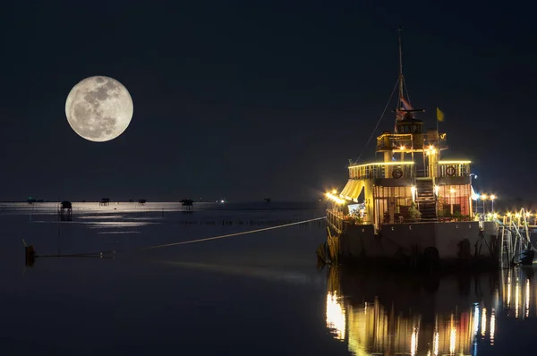 Full moon at dusk over House in the sea, Bang Ta Boon, Petchaburi, Thailand, Asia.