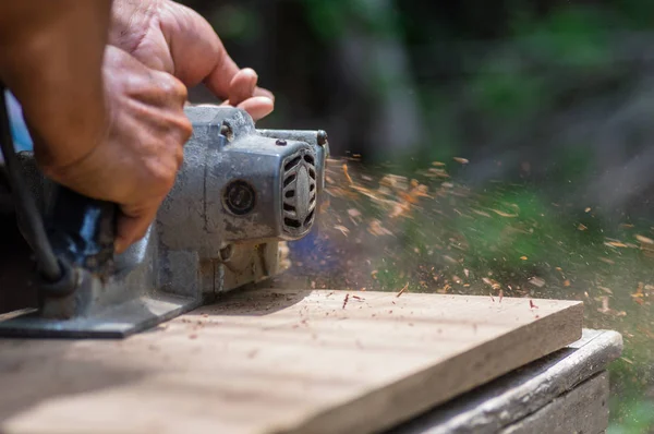 Sanding machine, The carpenter uses a polishing machine to smooth the wood. Soft focus. — Stock Image Sanding Machine Carpenter Uses Polishing Machine Smooth Wood Soft Focus Royalty Free Stock Photos