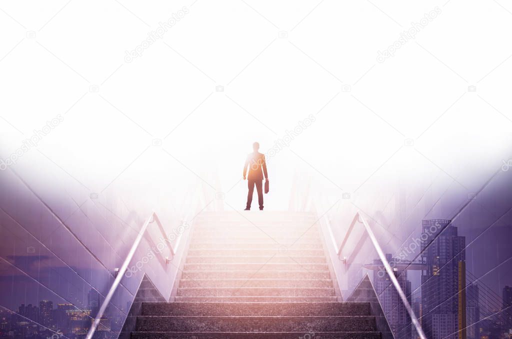 Rear view of a businessman climbing stairs, Concept into success.