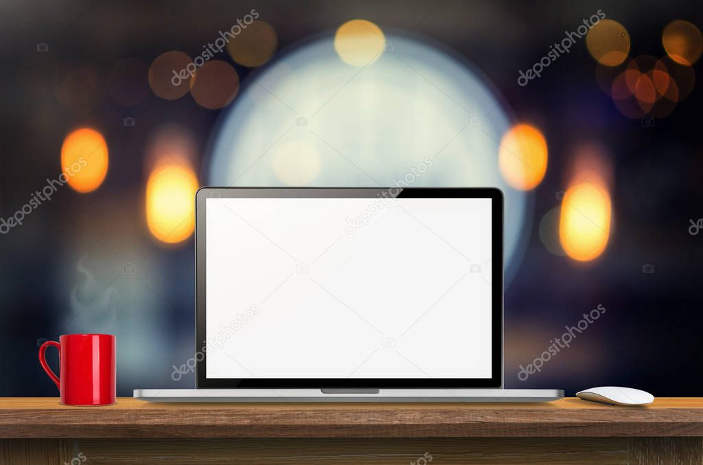 Laptop computer blank screen on wooden table and blurred Coffee shop interior background with bokeh image, for product display montage,can be used for montage or display your products