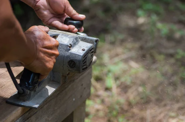 Sanding machine, The carpenter uses a polishing machine to smooth the wood. Soft focus. — Stock Image Sanding Machine Carpenter Uses Polishing Machine Smooth Wood Soft Focus Royalty Free Stock Images