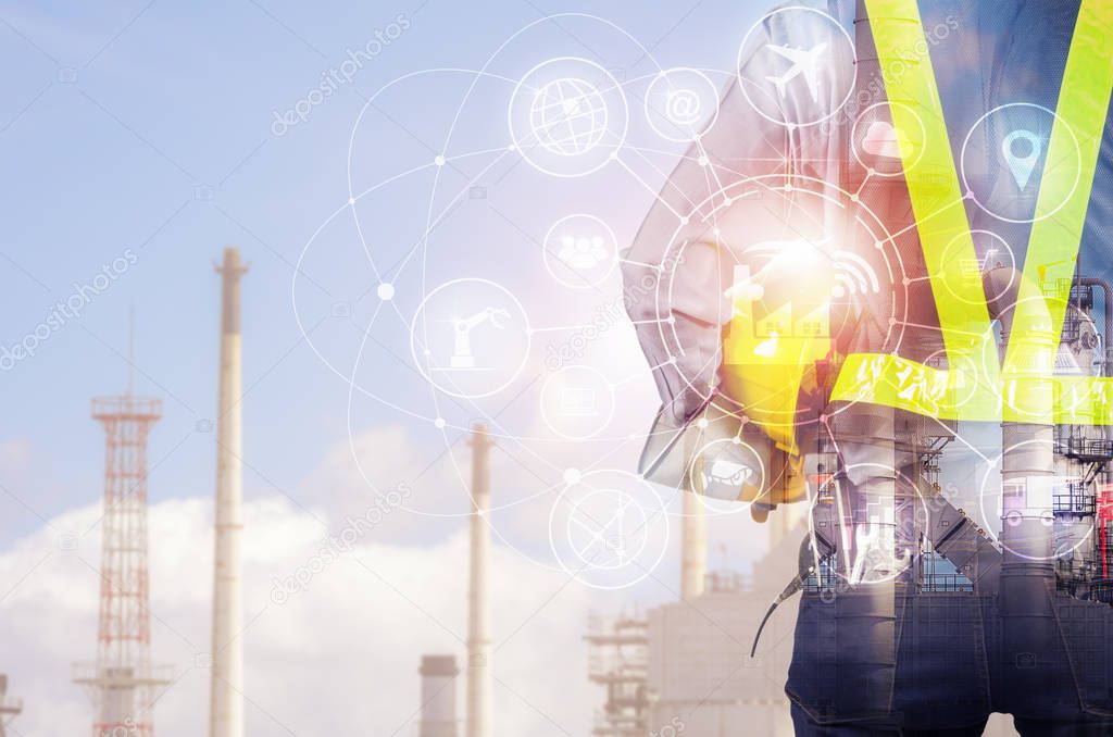 Double exposure of engineer behind with overload tool holding yellow helmet for safety of the workers, Blurred Oil refinery background, Industry 4.0 concept.
