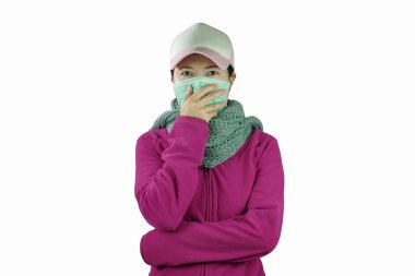 Woman with flu, woman dressed pink clothing wearing mask isolated on white background. Cold and flu concept 