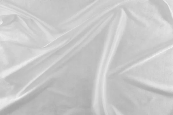 Smooth elegant white silk or satin luxury cloth can use as wedding background. Luxurious Christmas background or New Year background design. white fabric texture. Cloth Textile Surface. top view.