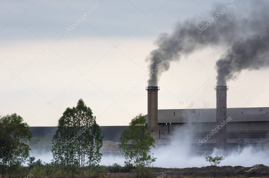 Air pollution with black smoke from chimneys and industrial waste.