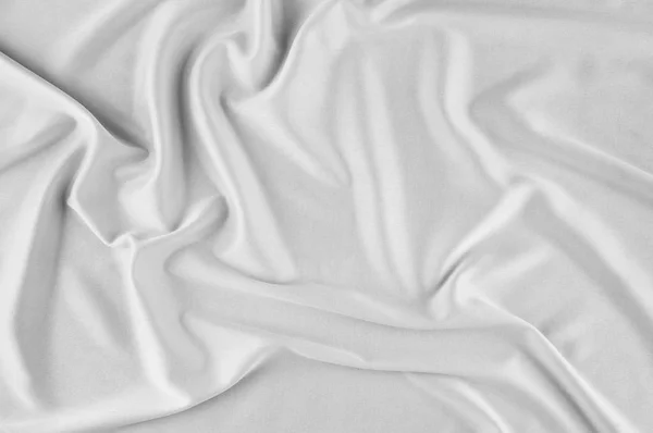 滑らかでエレガントな白シルクやサテンの高級布は 結婚式のバック グラウンドとして使用できます 豪華なクリスマスの背景や正月背景デザイン 白い布のテクスチャです 布織物表面 トップ ビュー — ストック写真