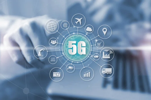 Businessman pressing on virtual screen 5G systems and Internet of things (IOT) word and objects icon connecting together, Internet networking concept, Connect global wireless devices with each other.