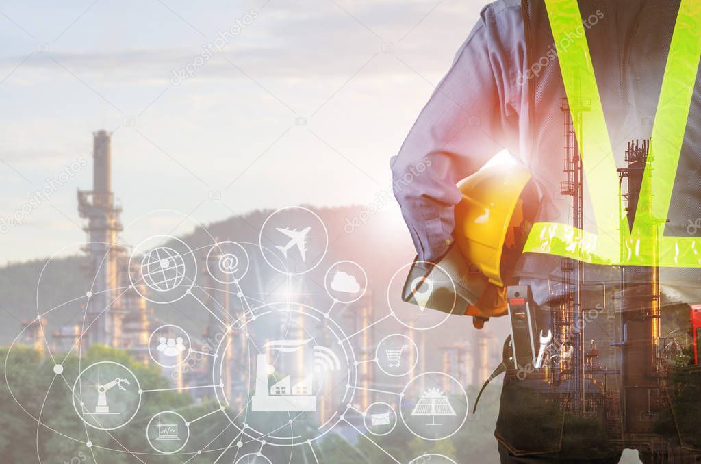 Double exposure of engineer holding yellow helmet and blurred Oil refinery background, Industry 4.0 concept.