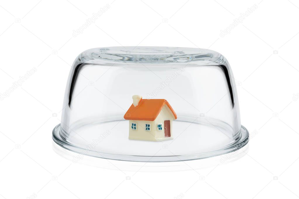 Protection concept, Toy home protected under glass dome, Property insurance.