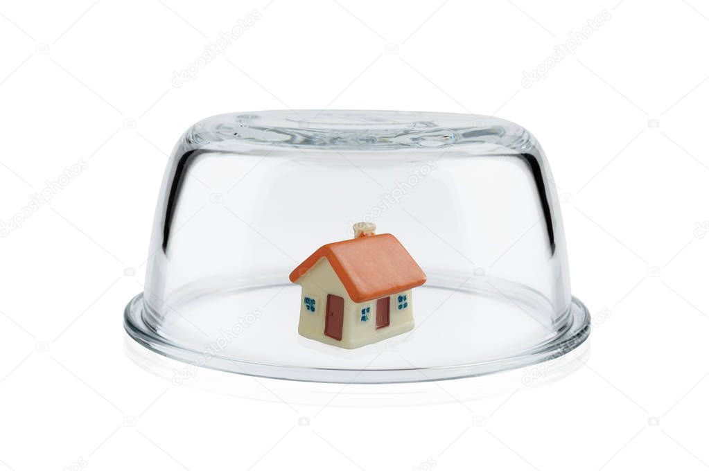 Protection concept, Toy home protected under glass dome, Property insurance.