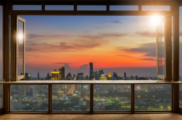 Beautiful Blank coffee shop or (cafe,restaurant) against blurred bangkok city view background, For montage product display or design key visual layout,  at sunrise.