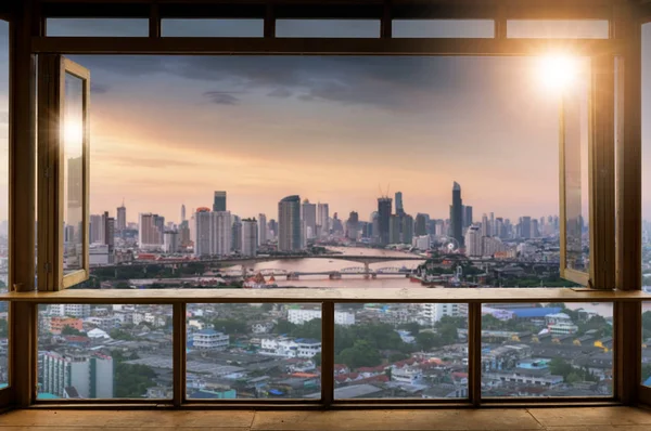 Beautiful Blank coffee shop or (cafe,restaurant) against blurred bangkok city view background, For montage product display or design key visual layout,  at sunrise.