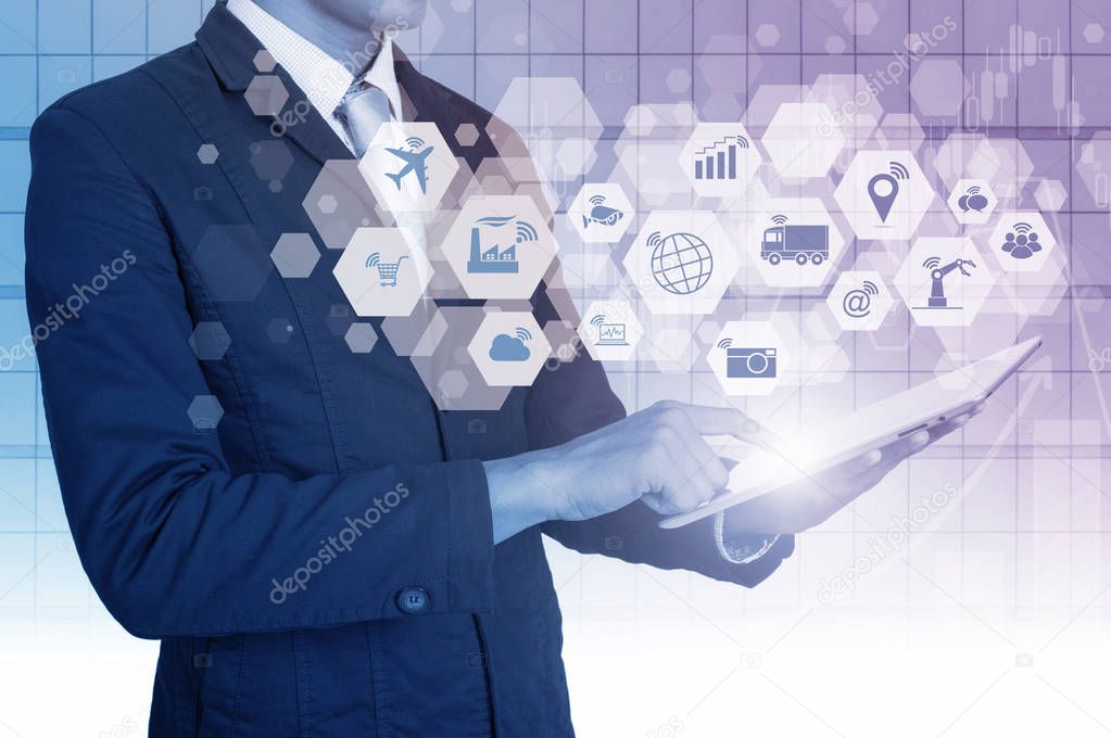 Double exposure of businessman and digital tablet and financial graph with Internet of things (IOT) objects icon and Internet networking concept, Connect global wireless devices with each other.