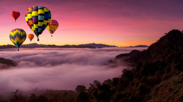 Beautiful colorful hot air balloons flying over mountain and mist at view point Sunrise of travel place, Baan jabo, Mae Hong Son is Hidden Paradise in Thailand.