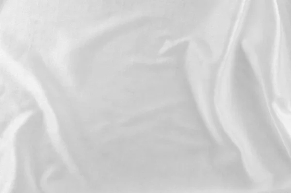 Smooth elegant white silk or satin luxury cloth as wedding background. Luxurious Christmas background or New Year background design. white fabric texture. Cloth Textile Surface. top view.