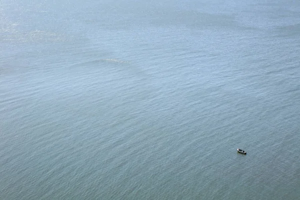 Little fisherman boat in the immense ocean