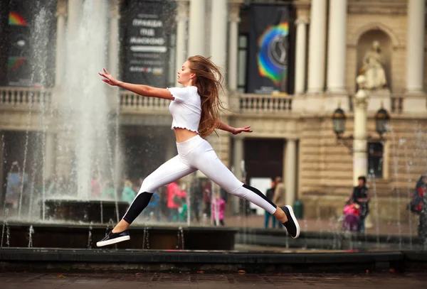 Sportovní Gymnastka Dívka Skákání Letu Ulici Starého Města Poblíž Kašny — Stock fotografie