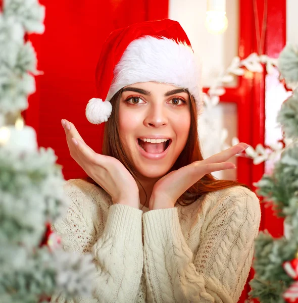 Joyful dreamy Santa woman on background Christmas tree — Stock Photo, Image