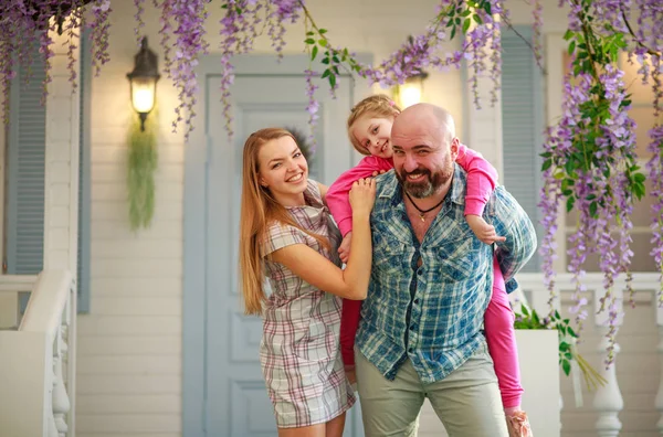 Young happy family having fun in courtyard of the summer house — 图库照片