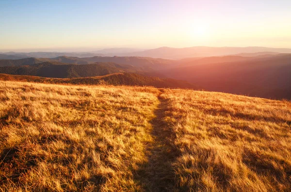 Mountain trail, hiking road on sunset sky background — Stock Photo, Image