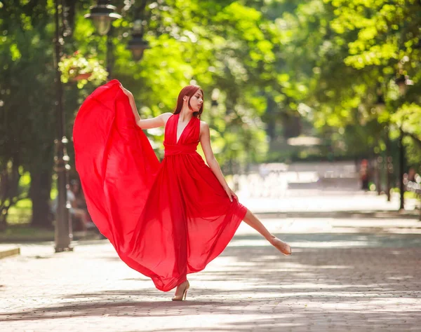 Young Woman Luxury Long Red Dress Dancing Jumping City Park — Stock Photo, Image