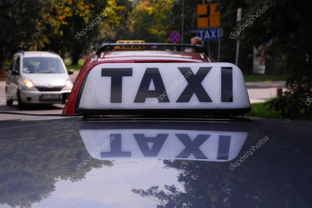 Poland, Krakow District-August, 23, 2019: Taxi stopped in traffic on a small street ...