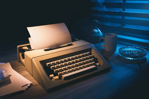 Old typewriter on a desk at night
