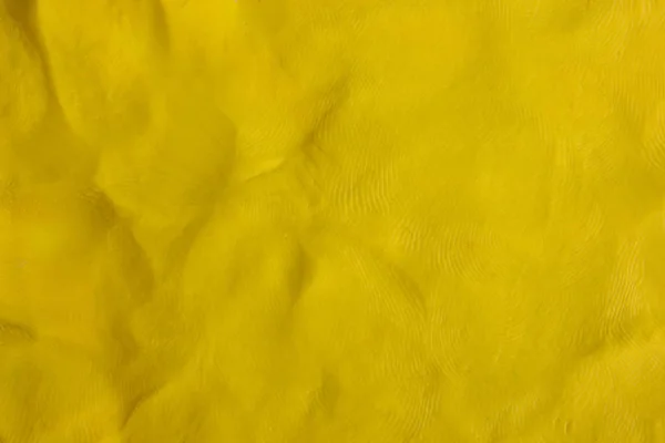 พื้นหลังโครงสร้างพลาสติกีนสีเหลือง — ภาพถ่ายสต็อก