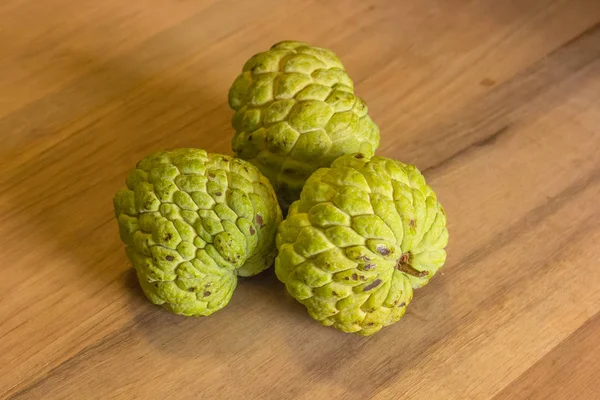 Sugar Apple (custard apple, Annona, sweetsop) on wood