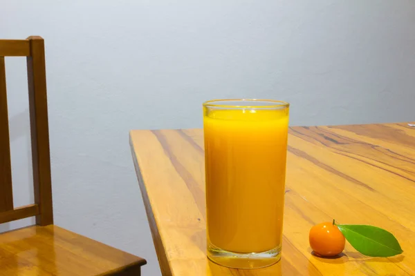 Orange juice and deletable imitation fruits on table wooden. loo — Stock Photo, Image
