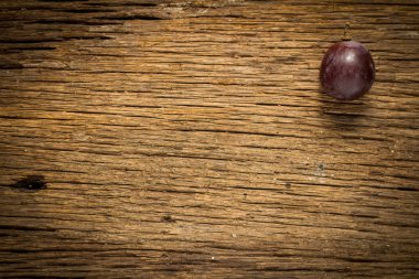 ahşap masa üstünde kırmızı üzüm 