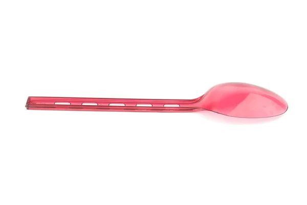 Red plastic spoon isolated on white — Stock Photo, Image