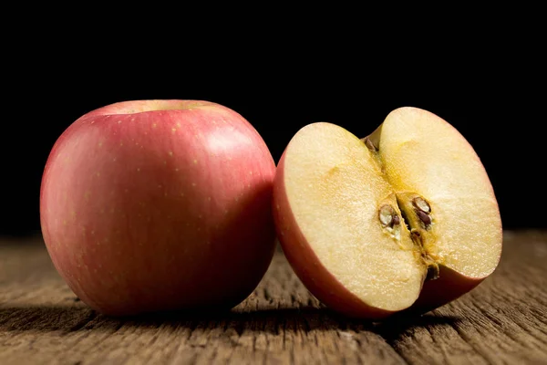Apfel auf Holz. schwarzer Hintergrund — Stockfoto