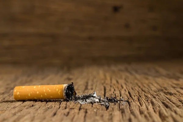 Tobacco cigarette. stub.  on wooden — Stock Photo, Image