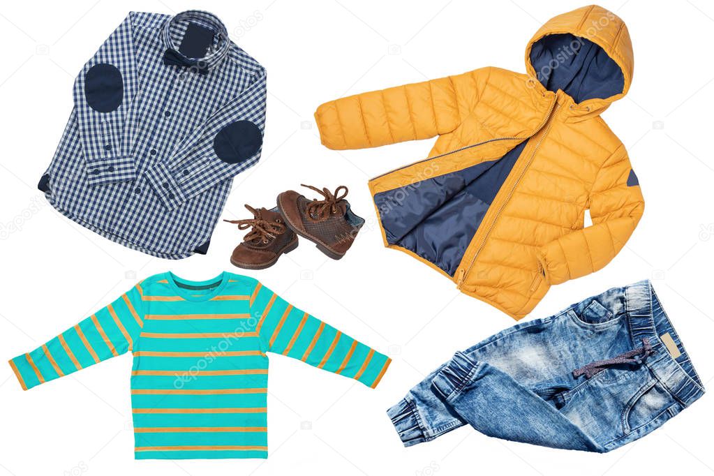 Top view on child boy set of clothes. Collage of apparel clothing. Jeans , shirt, shoes and warm down jacket isolated on a white background. Autumn and winter fashion.
